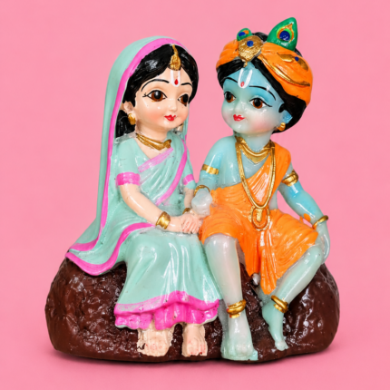 Handcrafted 9cm mini multi-colored radha krishna statue for gift purposes held in hand . Mini Radha Krishna Statue for Gift