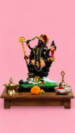 Handcrafted multi-colored Goddess Kali statue for home mandir setup resting on a wooden chowki