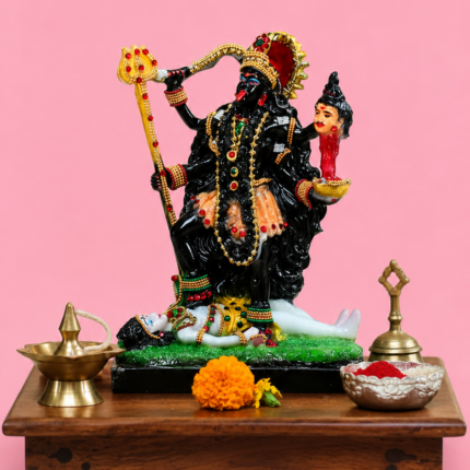 Handcrafted multi-colored Goddess Kali statue for home mandir setup resting on a wooden chowki