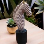 Abstract horse head sculpture with ribbed beige finish and black base by Elysee Decor