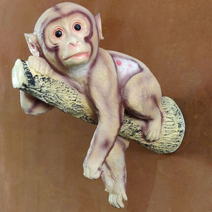 Wall hanging monkey showpiece in hand-painted resin on tree branch by Elysee Decor